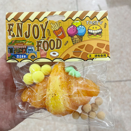 Jucarie Antistres Squishy, Cyrax, cu Revenire Lenta, Squeeze Pinch Family, Model Croissant, 10x8 cm, 90g, Ambalaj Transparent, Maro