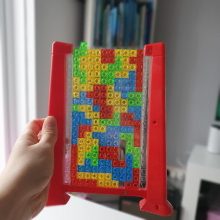 Joc de inteligenta Tetris puzzle tangram Cyrax, 70 de piese multicolore, 3D, montessori, interactiv, din plastic, zar inclus, sac depozitare piese, varsta peste 6 ani, 23 x 19.8 x 5 cm, cadru rosu